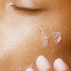 Alpha Refreshing Face Wash held in hand showing 6 oz scale advantage