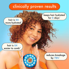 Applying Amika Hydro Rush mask on coily hair for easier detangling benefits