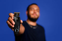 Andis GTX-EXO held in hand to show size and balance for comfortable professional use