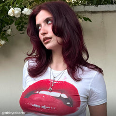 Hand applying ARCTIC FOX burgundy with brush to hair, demonstrates controlled, even color placement