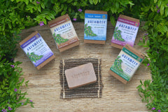 Auromere soap held in hand showing compact travel-friendly benefit
