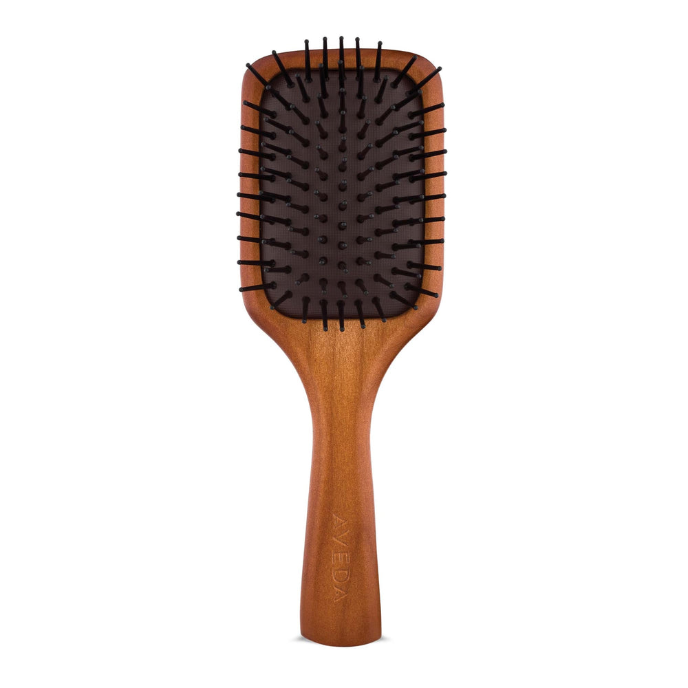 Aveda mini paddle brush front view showing compact design and paddle shape for travel convenience