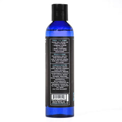 Badass Beard Care bottle held in hand demonstrating easy dispensing and control