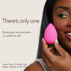 beautyblender damp sponge being squeezed to show aqua-activated expansion benefit