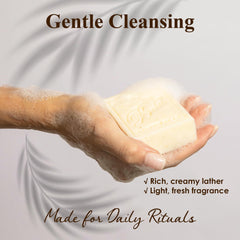 BELA soap in hand under water demonstrating gentle, non-drying cleanse