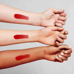 Benefit Benetint swiped on skin showing sheer rose tint and natural-looking flush benefit