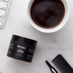 Brickell applying pomade to hands for even distribution and quick styling benefit