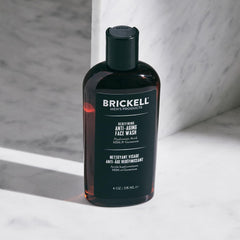 Brickell Men’s face wash held in hand to show 4oz scale and travel-friendly benefit