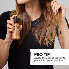 Bumble and bumble mini bottle held in hand for compact size and travel convenience
