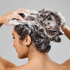 Bumble and bumble shampoo lather in hand demonstrating soft cleansing