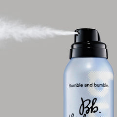 Bumble and bumble being sprayed onto wavy hair adding tousled movement
