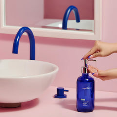 Capri Blue bottle next to everyday items showing 15 fl oz size and scale