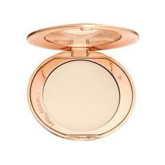Charlotte Tilbury compact front view showing sleek design and portability