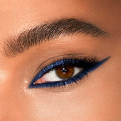 Charlotte Tilbury swatches of Super Blue matte and metallic on skin demonstrating intense color payoff