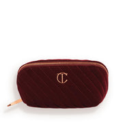 Charlotte Tilbury medium quilted velvet bag front view showing elegant night crimson finish and travel-ready style