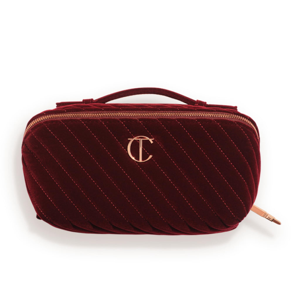 Charlotte Tilbury quilted velvet front view showing elegant night crimson and top handle benefit