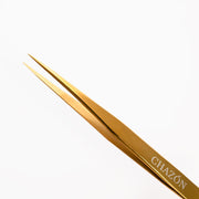 CHAZÓN gold tweezers front view showing sleek titanium finish and ergonomic shape for durable control