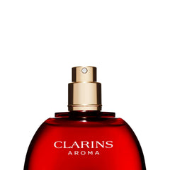 CLARINS lifestyle image of spray application for on-the-go freshness