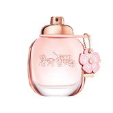 Coach bottle front view showing floral packaging and easy-pour benefit