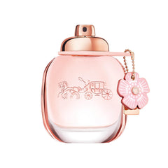 Coach bottle front view showing floral packaging and easy-pour benefit