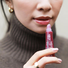 C. O. Bigelow close-up of glossy plum tint texture showing moisturizing shine