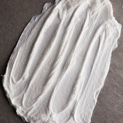 Man applying Cremo shave cream providing smooth, comfortable shave