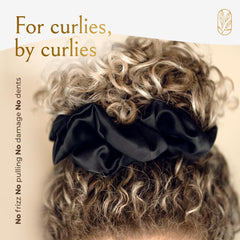 Curlfriend scrunchie held in hand illustrating oversized stretch and scale