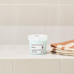 Davines conditioner being applied to wet hair for easier detangling