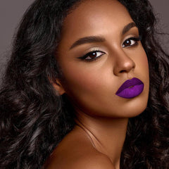 Depuplum swatch on arm displaying rich purple pigment and intense coverage benefit