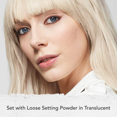 Dermablend loose powder on brush ready to set makeup for reduced shine