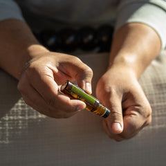 doTERRA Melaleuca Touch held in hand to show 10 mL size and portability
