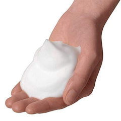 Dove bottle next to hand for scale showing large 34 fl oz size for long-lasting use