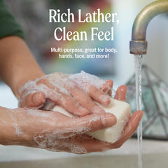 Dr. Bronner's eucalyptus bar held in hand to show 5 oz size and travel convenience