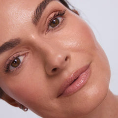 EarthsCure applying cream stick to cheek for instant natural radiance