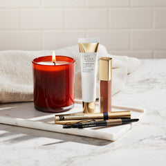 Estée Lauder spoolie blending brows on model for groomed arches and long-lasting finish
