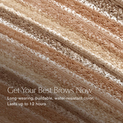 Estée Lauder Brow Now spoolie closeup blending color for natural finish