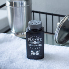 Floyd's 99 jar opened revealing powder and easy application benefit