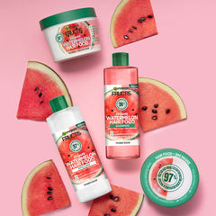 Model applying Garnier Fructis Watermelon Hairfood to fine hair for added volume and shine