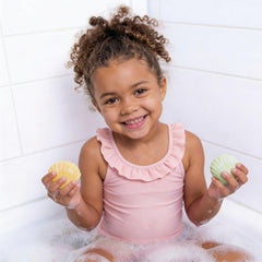 Generic bath bomb fizzing and dissolving in tub showing colorful, safe effect