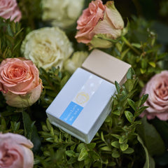 Giardini di Toscana body cream texture beside bottle to show layering benefit