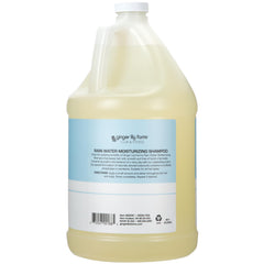 Ginger Lily Farms shampoo being pumped from a dispenser for easy commercial refills