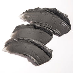 Glamglow SUPERMUD thick charcoal mud texture close-up demonstrating spreadability
