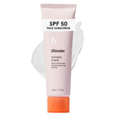 Glossier Invisible Shield front packaging shows compact 50 mL tube and clean design benefit: clear SPF protection