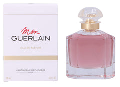 Guerlain Mon Guerlain next to hand for scale, conveys 3.3 oz travel convenience