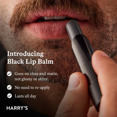 Applying Harry's balm on fingers to show clear finish and non-greasy feel benefit