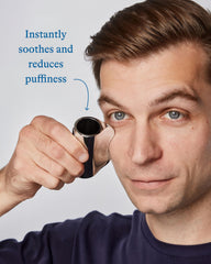 Harry's gua sha tool detail highlighting weighted zinc and ergonomic shape