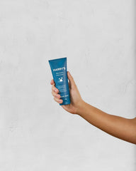 Hand lathering Harry's shaving cream into foam, demonstrating quick cushioning benefit
