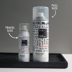 IGK mist dispersing in air to help reduce frizz and create shine quickly