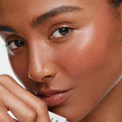 ILIA multi-stick being blended on cheek closeup showing natural-looking flush benefit