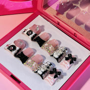IntoVibes front view showing black ballet ribbon press on nails and bold design benefit